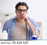 Young man is getting prepared for working day in bathroom. Стоковое фото, фотограф Elnur / Фотобанк Лори