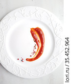 Ketchup in a sauce bowl on a white background. Стоковое фото, фотограф Марина Володько / Фотобанк Лори