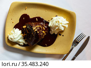 Delicate French chocolate fondant served with melted dark chocolate and whipped cream. Стоковое фото, фотограф Яков Филимонов / Фотобанк Лори