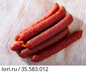 Tyrolean sausages and peppercorns on wooden table. Стоковое фото, фотограф Яков Филимонов / Фотобанк Лори