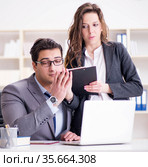 Sexual harassment concept with man and woman in office. Стоковое фото, фотограф Elnur / Фотобанк Лори