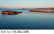 Озеро Байкал осенью. Остров Харанцы. Вид с воздуха. Lake Baikal in autumn. Kharantsi island. Aerial view. Стоковое видео, видеограф Евгений Романов / Фотобанк Лори