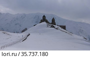 Gergeti Trinity Church against the mountain Kazbek. Georgia. Стоковое видео, видеограф Яков Филимонов / Фотобанк Лори