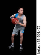 Basketball player, black background. Стоковое фото, агентство Ingram Publishing / Фотобанк Лори