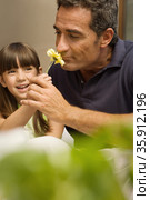 Girl and grandfather smelling flower. Стоковое фото, фотограф Shannon Fagan / Ingram Publishing / Фотобанк Лори