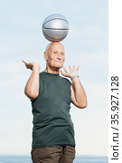 Man balancing basketball on his head. Стоковое фото, фотограф Shannon Fagan / Ingram Publishing / Фотобанк Лори