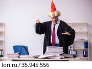 Funny young male employee magician and too much work in the office. Стоковое фото, фотограф Elnur / Фотобанк Лори