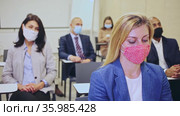 Side view of managers group in protective masks working at laptops in company office. Стоковое видео, видеограф Яков Филимонов / Фотобанк Лори