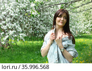 Beautiful young woman with cherry flowers in spring garden. Стоковое фото, фотограф ElenArt / Фотобанк Лори