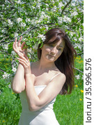 Beautiful young woman with cherry flowers in spring garden. Стоковое фото, фотограф ElenArt / Фотобанк Лори