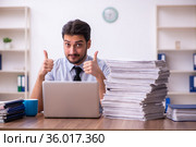 Young businessman employee unhappy with excessive work in the office. Стоковое фото, фотограф Elnur / Фотобанк Лори