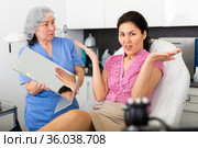 Female patient unhappy with results of cosmetic procedures in aesthetic clinic. Стоковое фото, фотограф Яков Филимонов / Фотобанк Лори