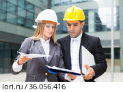 Smiling engineer and woman designer are estimating results of their project. Стоковое фото, фотограф Яков Филимонов / Фотобанк Лори