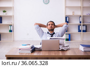 Young businessman employee unhappy with excessive work in the office. Стоковое фото, фотограф Elnur / Фотобанк Лори