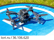 Moscow Russia - 30 may 2021: Close-up picture new aerial DJI FPV drone on fly landing pad. Top front view uav quad copter with 4K 60 fps Digital Camera and Remote control. travel in sunny summer day. Редакционное фото, фотограф Алексей Ширманов / Фотобанк Лори