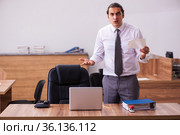 Young male employee unhappy with office prank in the office. Стоковое фото, фотограф Elnur / Фотобанк Лори