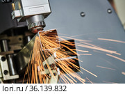Laser cutting of metal pipe with sparks on tube laser machine. Стоковое фото, фотограф Дмитрий Калиновский / Фотобанк Лори