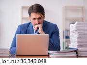 Young businessman employee and too much work in the office. Стоковое фото, фотограф Elnur / Фотобанк Лори