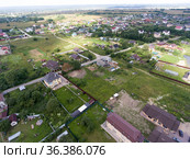 Aerial view at a village with summer houses and cottages close to asphalt road. Стоковое фото, фотограф Кекяляйнен Андрей / Фотобанк Лори