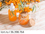 Hippophae homemade sea buckthorn oil in a glass bottle with a pipette on the background with a copy space, alternative herbal medicine and cosmetology. Стоковое фото, фотограф Светлана Евграфова / Фотобанк Лори