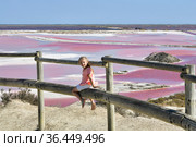 A girl at the Salin-de-Giraud salt farm with pink salty water. Стоковое фото, фотограф Irina Kuchugurina/Gaudy / Фотобанк Лори