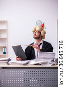 Funny young male employee magician and too much work in the office. Стоковое фото, фотограф Elnur / Фотобанк Лори