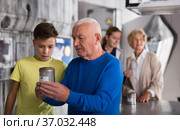 Grandson together with his grandfather solve the riddles of quest room. Стоковое фото, фотограф Яков Филимонов / Фотобанк Лори