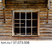 Window frame with broken glass in the wall of an old abandoned wooden house. The picture was taken in the village of Pervokrasnoe, in the Orenburg region. Стоковое фото, фотограф Вадим Орлов / Фотобанк Лори