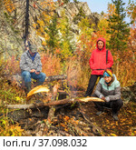 Russia Beloretsk September 2019 A group of tourists warms up by a bonfire at the top of Mount Malinovaya in the Southern Urals. Редакционное фото, фотограф Акиньшин Владимир / Фотобанк Лори