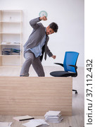 Young male employee working overtime in the office. Стоковое фото, фотограф Elnur / Фотобанк Лори