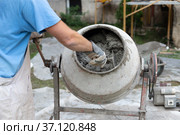 Labore worker operating concrete cement mixer at construction site. Стоковое фото, фотограф Matej Kastelic / Фотобанк Лори