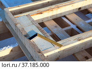Steel square tool is on timber logs, construction site. Стоковое фото, фотограф Кекяляйнен Андрей / Фотобанк Лори