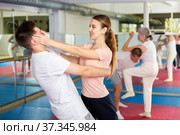 Woman performing eye-gouging move during self-defence training. Стоковое фото, фотограф Яков Филимонов / Фотобанк Лори