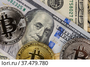 Bitcoin coins lie on dollars. Стоковое фото, фотограф Kozub Vasyl / Фотобанк Лори