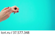 Female hands holding cosmetic eye liner pencils against blue background. Стоковое видео, видеограф Сергей Толмачёв / Фотобанк Лори