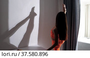 Fitness at home - young woman stretching her leg standing by the wall. Стоковое видео, видеограф Константин Шишкин / Фотобанк Лори