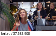 Delighted young female client sitting in hairdressing chair after haircut from professional stylist. Стоковое видео, видеограф Яков Филимонов / Фотобанк Лори
