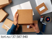Above table top view of warehouse preparing post courier delivery package. Стоковое фото, фотограф Сергей Толмачёв / Фотобанк Лори