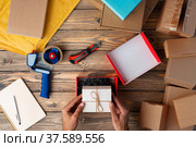 Packing products for delivery on wooden table, top view. Стоковое фото, фотограф Сергей Толмачёв / Фотобанк Лори