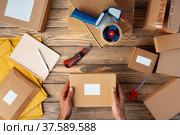 Packing products for delivery on wooden table, top view. Стоковое фото, фотограф Сергей Толмачёв / Фотобанк Лори