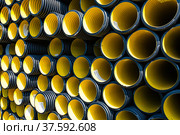 Plastic pipes production plant warehouse. Yellow PVC channelled pipes. Стоковое фото, фотограф Alexey Rezvykh / Фотобанк Лори