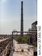 Plant chimney (smoke stack) and pipelines. Chemical plant on grey sky. Phosphoric fertilizers production. Стоковое фото, фотограф Alexey Rezvykh / Фотобанк Лори