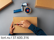 Above table top view of warehouse preparing post courier delivery package. Стоковое фото, фотограф Сергей Толмачёв / Фотобанк Лори