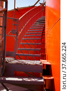 Orange steel storage tanks with acid and stairs on sulfuric (sulphuric) acid plant warehouse. Light blue sky background. Стоковое фото, фотограф Alexey Rezvykh / Фотобанк Лори