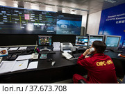 Oil refinery plant. Operation control center and operator in red work wear controlling process. CNPC company. (2012 год). Редакционное фото, фотограф Alexey Rezvykh / Фотобанк Лори