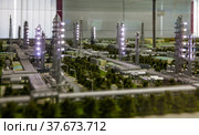 Aktobe region/Kazakhstan - May 04 2012: Scale miniature (maquette) of modern oil refinery and gas processing plant. Distillation columns. Night lights. Редакционное фото, фотограф Alexey Rezvykh / Фотобанк Лори