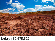 Aluminium ore quarry. Bauxite clay open-cut mining. Heaps of empty stones with green grass on background. Blue sky with clouds. Стоковое фото, фотограф Alexey Rezvykh / Фотобанк Лори