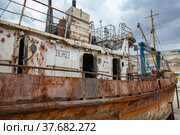 Mangystau, Kazakhstan - May 19, 2012: Old rusted ship on ship-repairing yard. Caspian Sea, Bautino bay. Doors and portholes of deck-office. Стоковое фото, фотограф Alexey Rezvykh / Фотобанк Лори