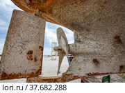 Mangystau, Kazakhstan - May 19, 2012: Old rusted ship in Bautino. Caspian Sea ship-repairing yard. Close up of water propeller and ship's bottom with shellbacks. Стоковое фото, фотограф Alexey Rezvykh / Фотобанк Лори