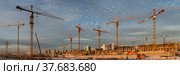 Panoramic view of a large construction site with many tower cranes (2021 год). Стоковое фото, фотограф Юлия Бабкина / Фотобанк Лори